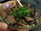Red beans and rice garnished with chopped flat parsley and green onions.