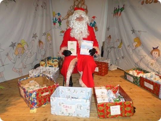 Father Christmas waits to give presents to a boy and girl