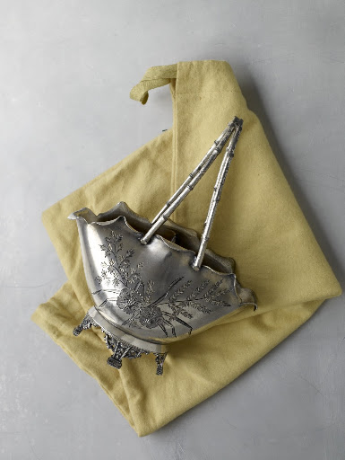 A Victorian silver-plate basket has bamboo-shaped handles inspired by the Far East.