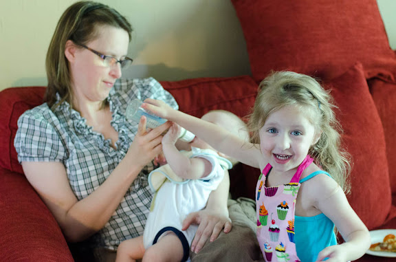 Sam helping mom to feed Nate