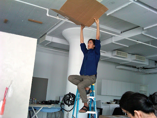 Air from a ceiling vent was blowing the fringe all about -- Nick blocked the flow like a pro.