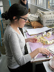 Athena set up a little work station by the window and crafted the finishing touches for our escort card display.