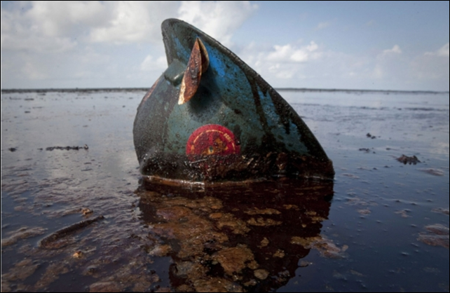 A hard hat from an oil worker lies in oil from the Deepwater Horizon spill on East Grand Terre Island, Louisiana. Photo: Lee Celano / Reuters