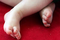Tiny feet on the picnic rug