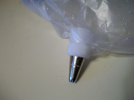 Snip off a small corner of the liner and add an icing tip (with or without a coupler) then add the icicing and decorate.