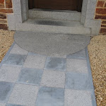 Entrance with honed and bush hammered tiles