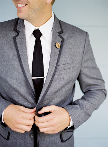 The lapel of the wedding suit was decked with a whimsical vintage gold dog pin.