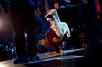 3T of Vietnam performs as Taisuke of Japan watches on during the Red Bull BC One breakdancing world finals at the Circus Nikulin in Moscow, Russian Federation on November 26, 2011.