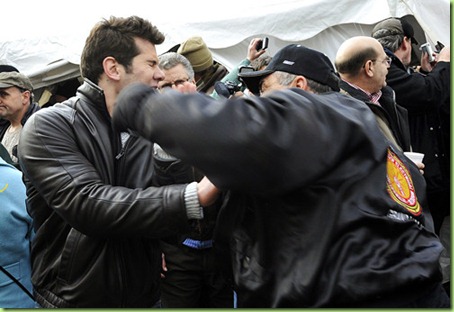 (caption) In this sequence of photos a man in a IBEW Union jacket punches another man in the face outside the pro-Right-to-Work tent of Americans for Prosperity,an organization funded by big money private doners.  *** Union members and labor supporters protest Right-to-Work legislation at the Michigan State Capitol in Lansing Tuesday morning. Photos taken on Tuesday, December 11, 2012. ( John T. Greilick / Detroit News )

