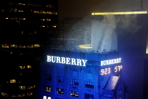 Confetti cannons explode as a part of Burberry's sign lighting ceremony. Confetti cannons explode as a part of Burberry's sign lighting ceremony.