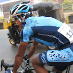 Haidar Anuawar from the Marco Polo Cycling Team training in Mumbai with a tuk-tuk in the background. (Photo: Remko Kramer)