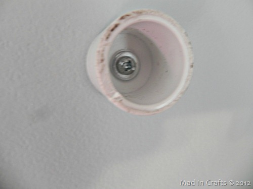 PVC pipe cap screwed into wall