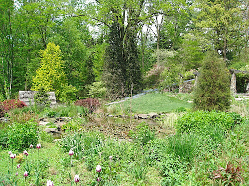 Looking down the slope, you can see the roof of the spring house on the left and more inventive plantings. It isn't all about the little herbaceous things - there are plenty of woody plants that lend structure and texture.