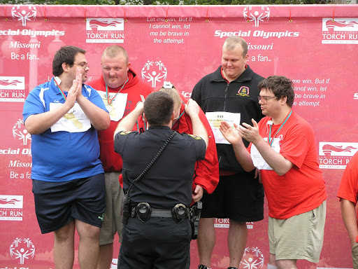 A member of the Springfield Police Department presenting medals to Special Olympics athletes.
(Photo credit: Jeremy Shreckhise)