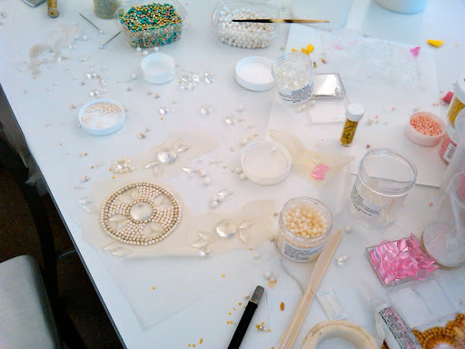 One by one, we glued the Fancy Flours pearls, dragees, and various gems onto muslin to create the finished piece.