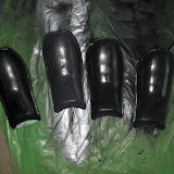 Ryo's inner shoulder armor.  Leftmost is the original (insulation foam coated with smooth cast plastic), the others are castings, either fiberglass or fiberglass-plastic hybrids