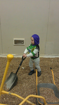 Space ranger digging at Nisa night at the magic house
