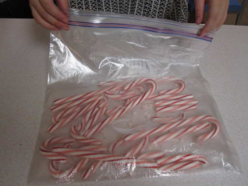 Put the candy canes into a zip-top bag. My daughter, V, was on hand to help.