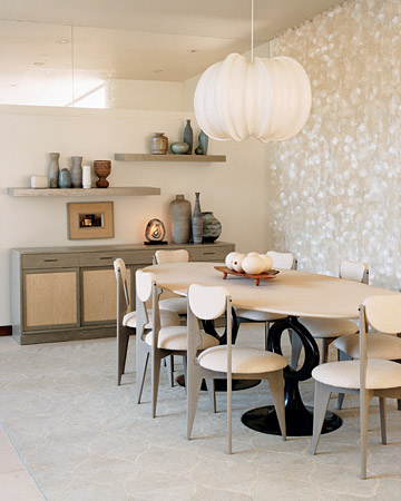 A capiz-shell curtain creates a shimmering backdrop in the dining area, which is mostly soft whites and cool grays.