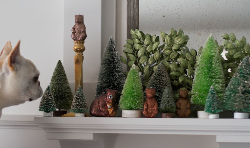 The mantle is covered snow-covered trees, glittered foliage and beautiful brown bear ornaments.