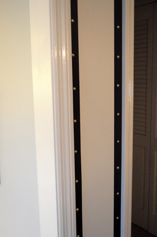 grosgrain ribbon and upholstery tacks around doorways