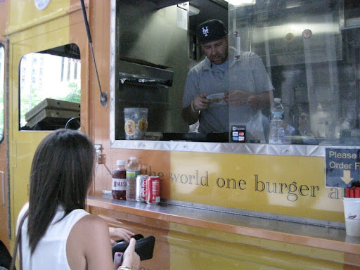 Allison ordering her burger and fries from Frites n Meats