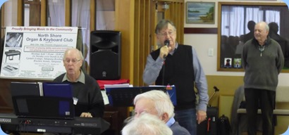 Peter Brophy and Len Hancy entertaining the members with a sing-along session. With George Watt in the background