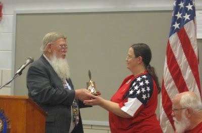 American Legion Post 29 Commander Robert Kennedy presents an American Legion Auxillary bell to Mary Seifert