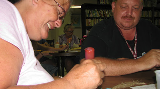 Betty McKelvy uses glitter glue to write on her bookmark.