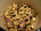 Eggplant cooks with onions until almost tender.