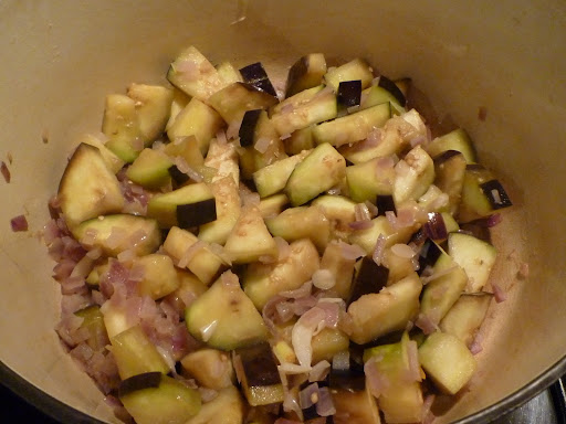 Eggplant cooks with onions until almost tender.