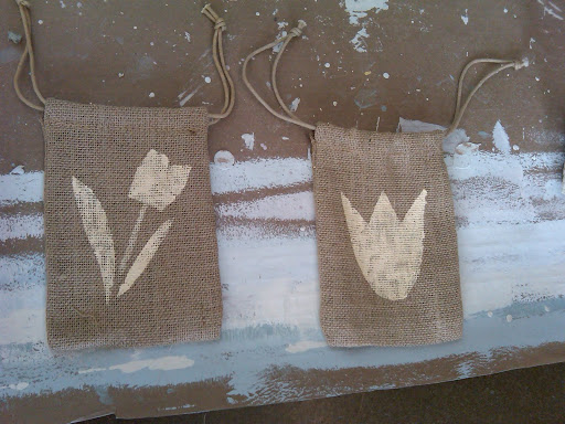 We loved the idea for tulip-bulb favor in a stenciled burlap bag. We tested a couple of stencils before choosing the one on the left. We loved the idea for tulip-bulb favor in a stenciled burlap bag. We tested a couple of stencils before choosing the one on the left.