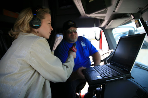 KSMU's Jennifer Moore interviews O&S Trucking's Patrick McGuire about the electronic devices he uses in the cab of his truck. (Photo Credit: Alex Crowder)