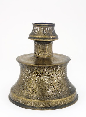 Candlestick decorated with astrological symbols | Origin:  Turkey | Period: late 13th century | Details:  Not Available | Type: Brass or bronze, inlaid with silver and black filling | Size: H: 20.0  W: 19.7   D: 19.7  cm | Museum Code: F1981.27 | Photograph and description taken from Freer and the Sackler (Smithsonian) Museums.