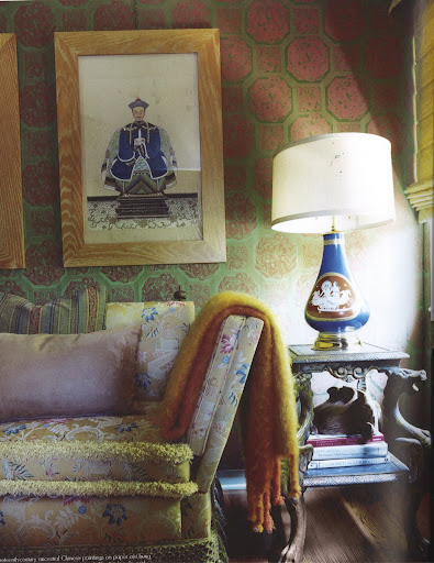 Nineteenth-century ancestral Chinese paintings on paper are hung on walls upholstered in vintage jacquard. The Knole sofa and Venetian side table are both nineteenth-century . The porcelain lamp is 1950s Italian. (Dealer's Choice, Architecture/Interiors Press, Inc.)