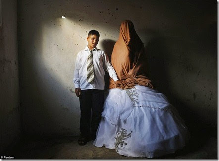 Palestinian groom Ahmed Soboh, 15 and his bride Tala, 14, stand inside Tala's house during their wedding party in the town of Beit Lahiya, near the border between Israeli and Gaza Strip September - Copy Palestinian groom Ahmed Soboh, 15 and his bride Tala, 14, stand inside Tala's house during their wedding party in the town of Beit Lahiya, near the border between Israeli and Gaza Strip September - Copy