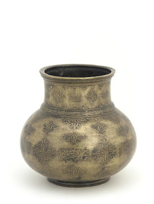 Jug (mashrabah) | Origin:  Iran | Period: early 16th century  Safavid period | Details:  Not Available | Type: Brass, traces of gold and silver inlay | Size: H: 12.8  W: 13.3  cm | Museum Code: F1977.4 | Photograph and description taken from Freer and the Sackler (Smithsonian) Museums.