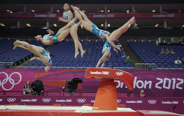 In this multiple exposure photo, a Brazilian gymnast performs on the vault during training at the 2012 Summer Olympics, Thursday, July 26, 2012, in London. (AP Photo/Julie Jacobson)