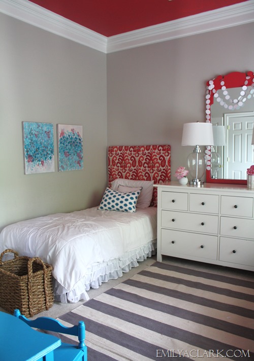 girls bedroom with ikat headboard, striped rug and painted ceiling