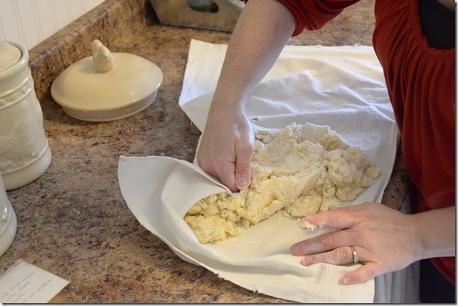 woman kneading sugar cookie dough on a pastry cloth