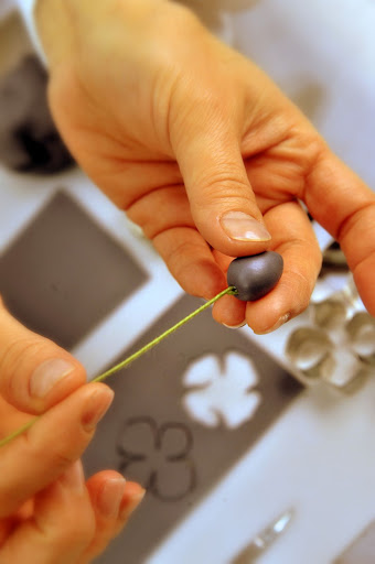 She inserts the stem.