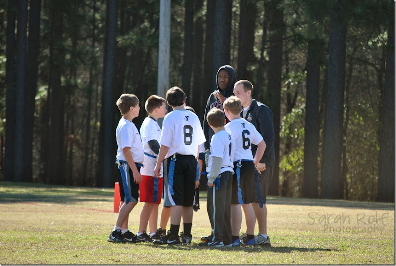 boys in football huddle