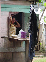 Date: 2003

Location: Roatan Island, Honduras

Story: Out for a walk. This beautiful woman is performing her morning constitutionals. I took two pictures of her. She is not looking at in the first. I am not sure who caught whom int he second instance.