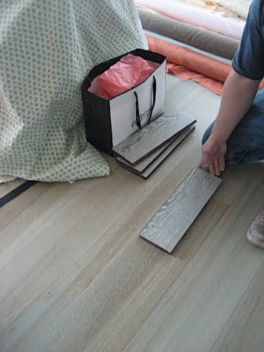 Bob had a great idea to use some of the sample flooring pieces to patch up the floor in the laundry area.