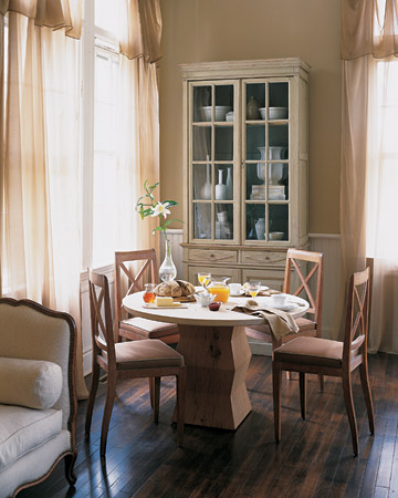 In this very Parisian breakfast room, there is as much cream as there is coffee: An eggshell-colored cupboard, curtains of pale chiffon, light woods, tan piping on the seat cushions, and snowy wainscoting all help to enrich the cafe au lait brown of the walls. In this very Parisian breakfast room, there is as much cream as there is coffee: An eggshell-colored cupboard, curtains of pale chiffon, light woods, tan piping on the seat cushions, and snowy wainscoting all help to enrich the cafe au lait brown of the walls.