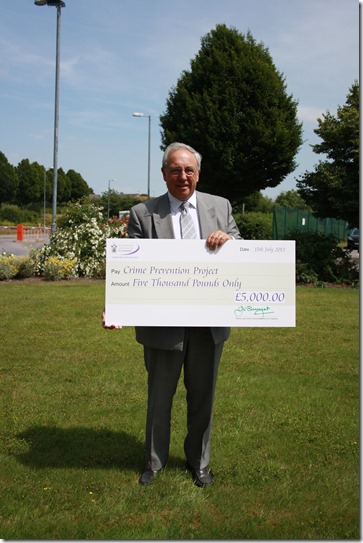 John Dwyer with cheque for Crime Prevention Fund