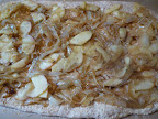 Top the pizza crust with the onion-apple mixture and add a little rosemary.