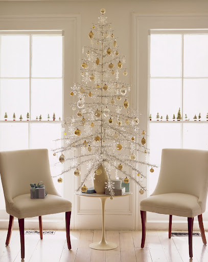 The sparse branches of a 1960s aluminum tree provide plenty of room to show off ornaments. The tree is anchored in a sand-filled vase, which replaces its base.