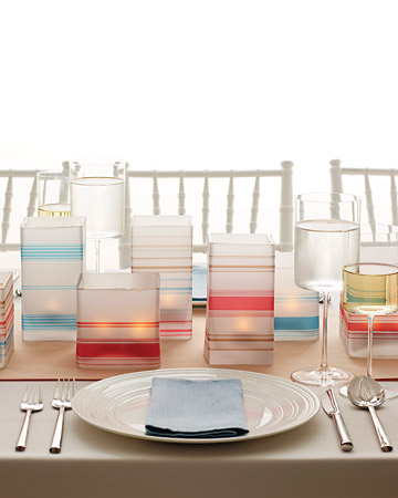 This modern nod to luminarias -- paper bags with votives inside -- updates the look with chic stripes printed onto vellum and wrapped around straight-sided square glass vases. (marthastewartweddings.com) This modern nod to luminarias -- paper bags with votives inside -- updates the look with chic stripes printed onto vellum and wrapped around straight-sided square glass vases. (marthastewartweddings.com)