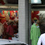 A small band playing happy hardcore twang guitar to attract local shoppers.